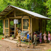 Students at an alternative elementary school entering their rustic open-air classroom at the beginning of a school day