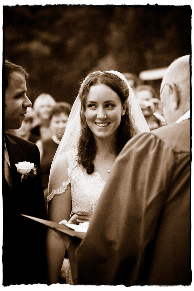 Alicia sneaks a knowing look at her groom during the ceremony at The Kaaterskill in the Hudson Valley.