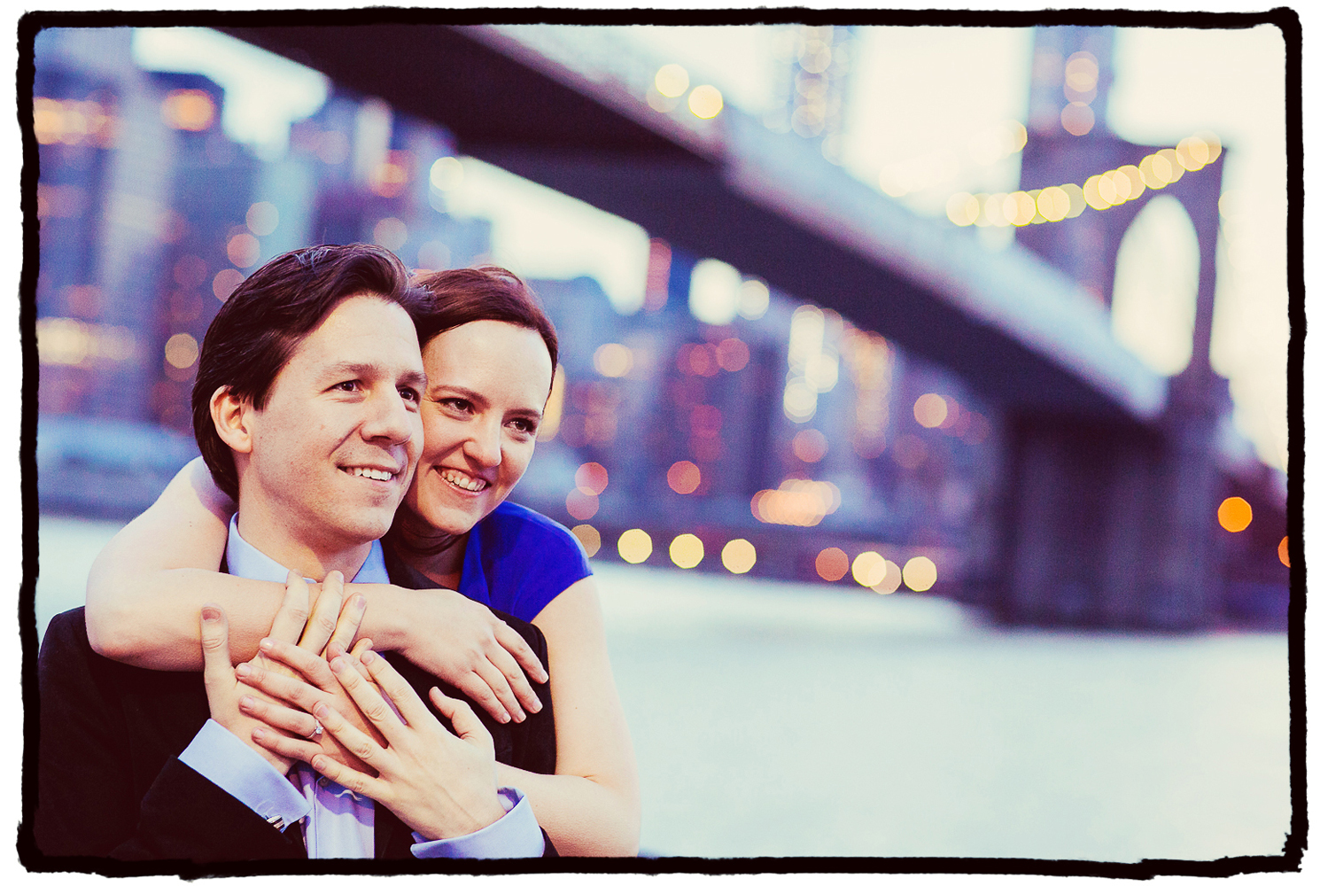 Engagement Portrait: Laura & Axuve enjoy the city skyline from Brooklyn Bridge Park.