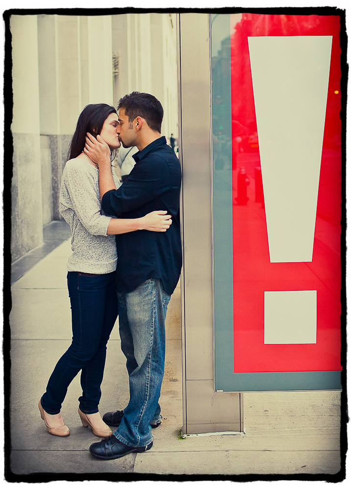 Engagement Portraits: a bus stop sign punctuates a kiss!