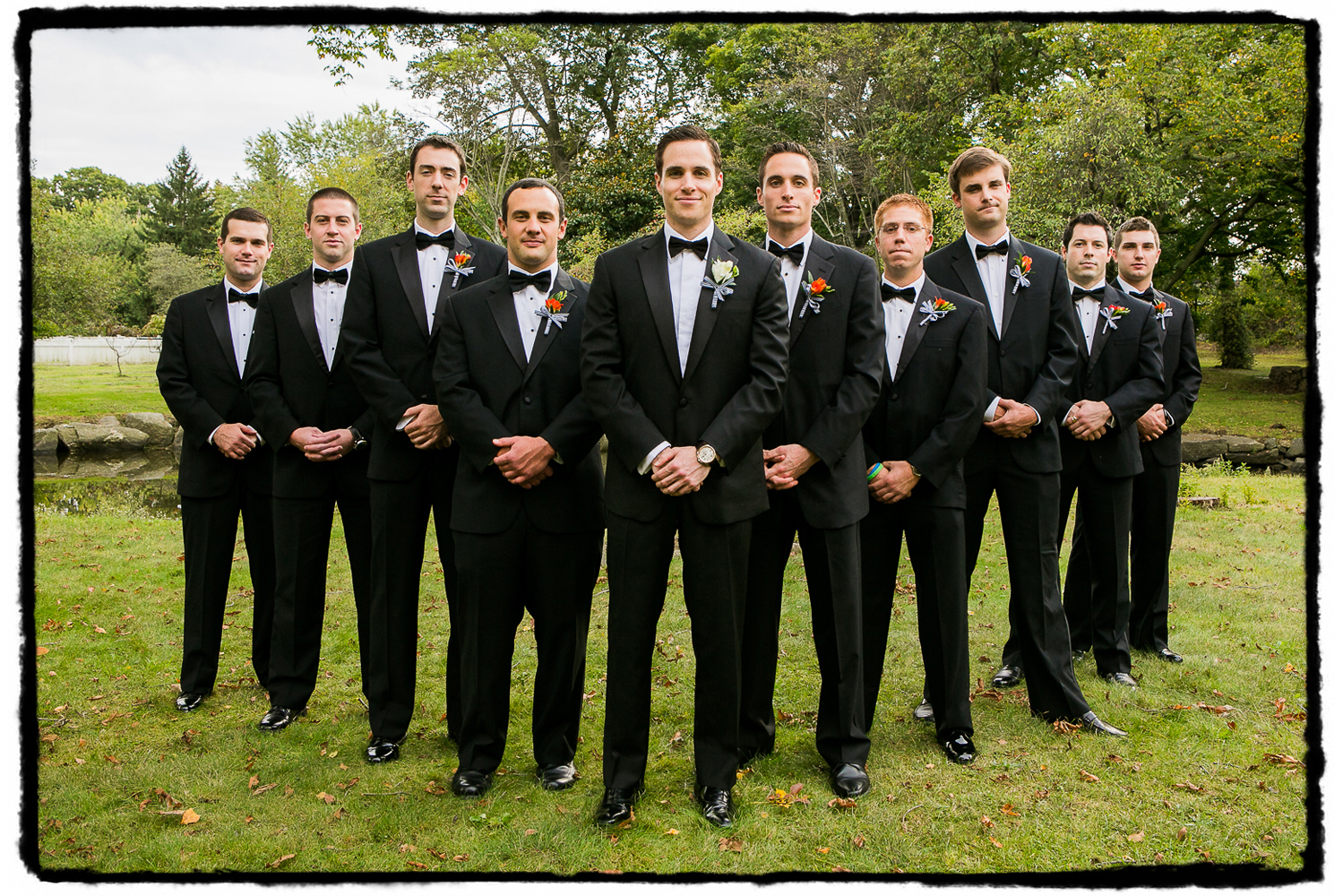 Mike and his groomsmen in black tie at the park in Greenwich, CT.
