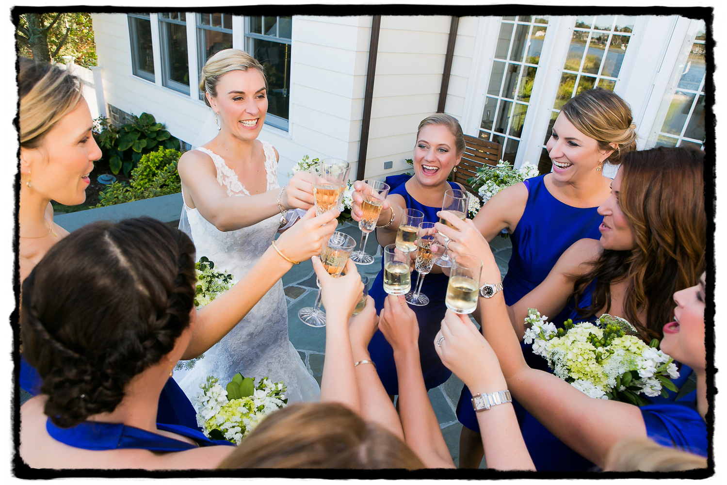 Carrie and her bridesmaids share a toast on her parents' back deck before heading to the wedding at Belle Haven Club in Greenwich, CT.