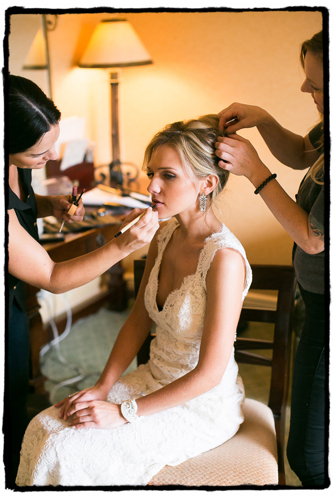 Devin's hair and makeup gets a final touchup after putting on her wedding gown in Greenwich, CT..