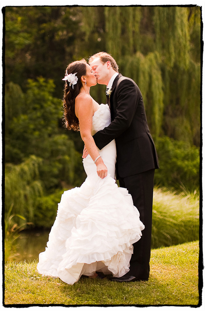 Alex and Michele share a sweet kiss in front of the weeping willows at Buttermilk Falls in the Hudson Valley.