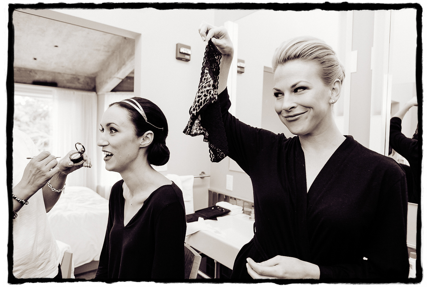 Shannon's maid of honor makes her laugh as she gets her makeup done in the bridal suite at The Roundhouse..